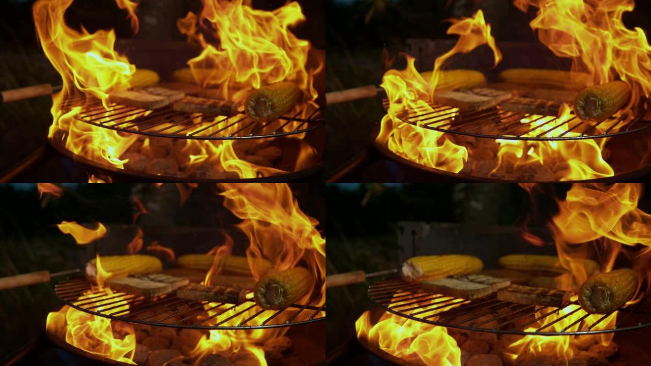 慢动作: 火焰从烧烤架上的热木炭和烤肉中冒出。
