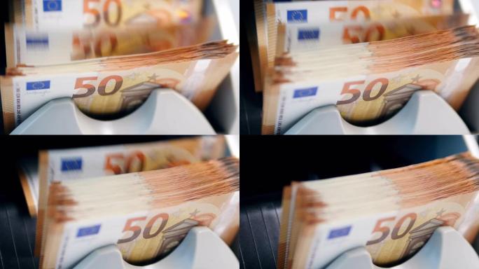 在银行设备中计数的印刷欧元钞票。