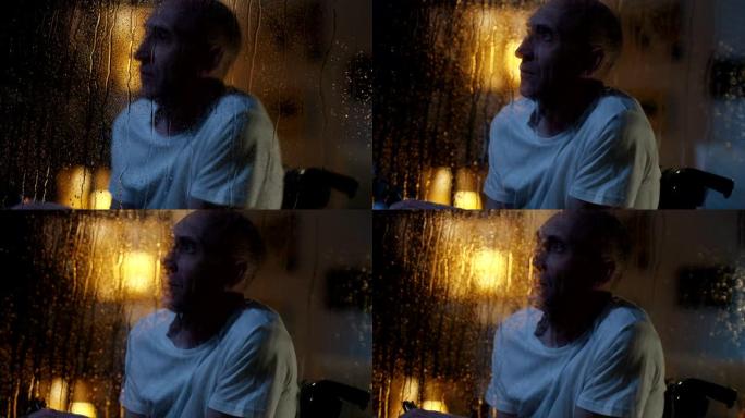残疾人观看风暴暴风雨夜晚玻璃上水珠孤独的