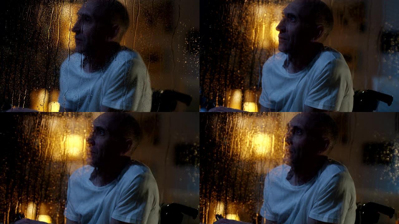残疾人观看风暴暴风雨夜晚玻璃上水珠孤独的