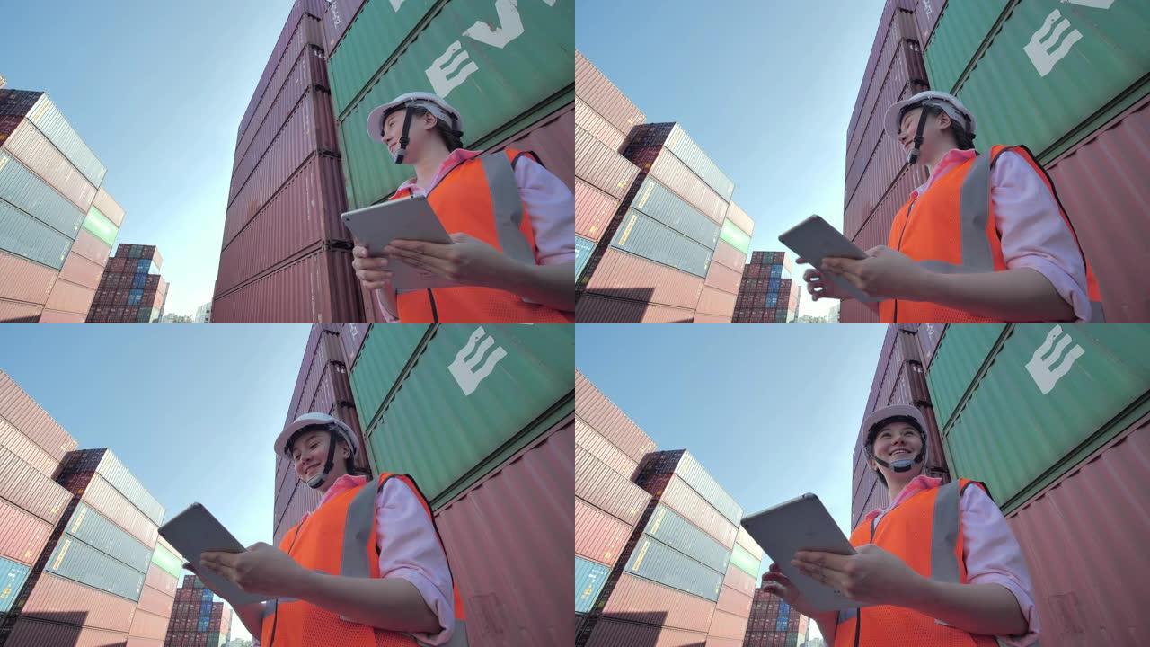 快乐的亚洲女性工程师控制从货物货运装载集装箱箱。技术，交付，商业，增长，连接，沟通，商业，授权，领导