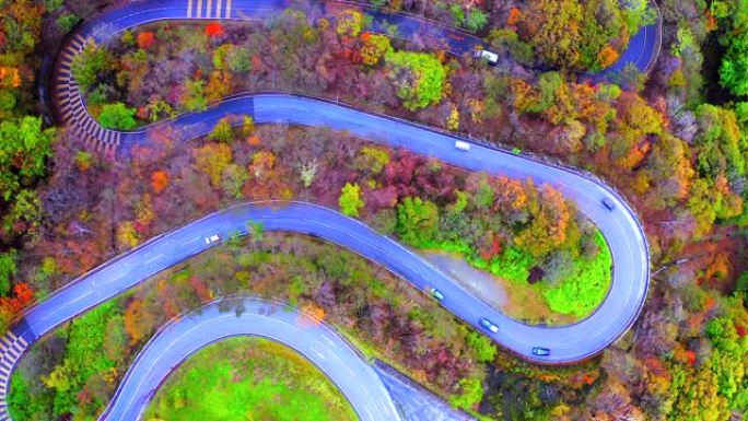日本秋天在山上来回弯曲的道路的鸟瞰图