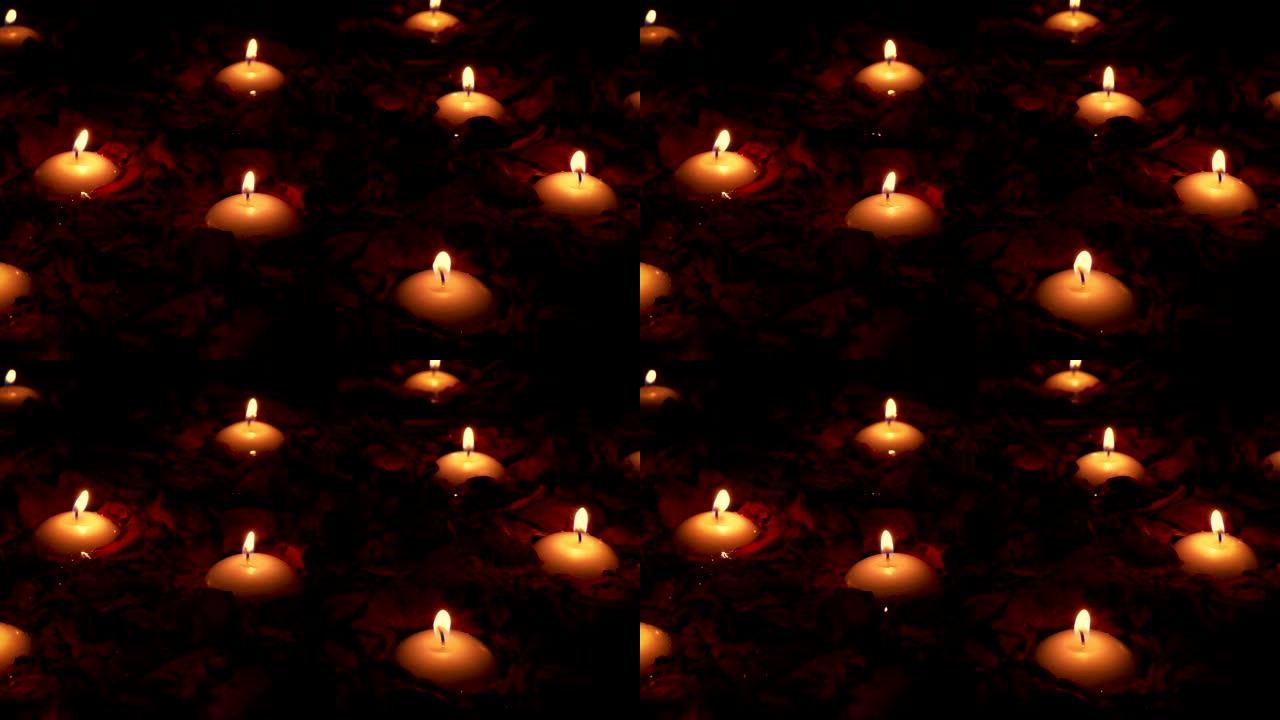 玫瑰花瓣浪漫场景中的蜡烛