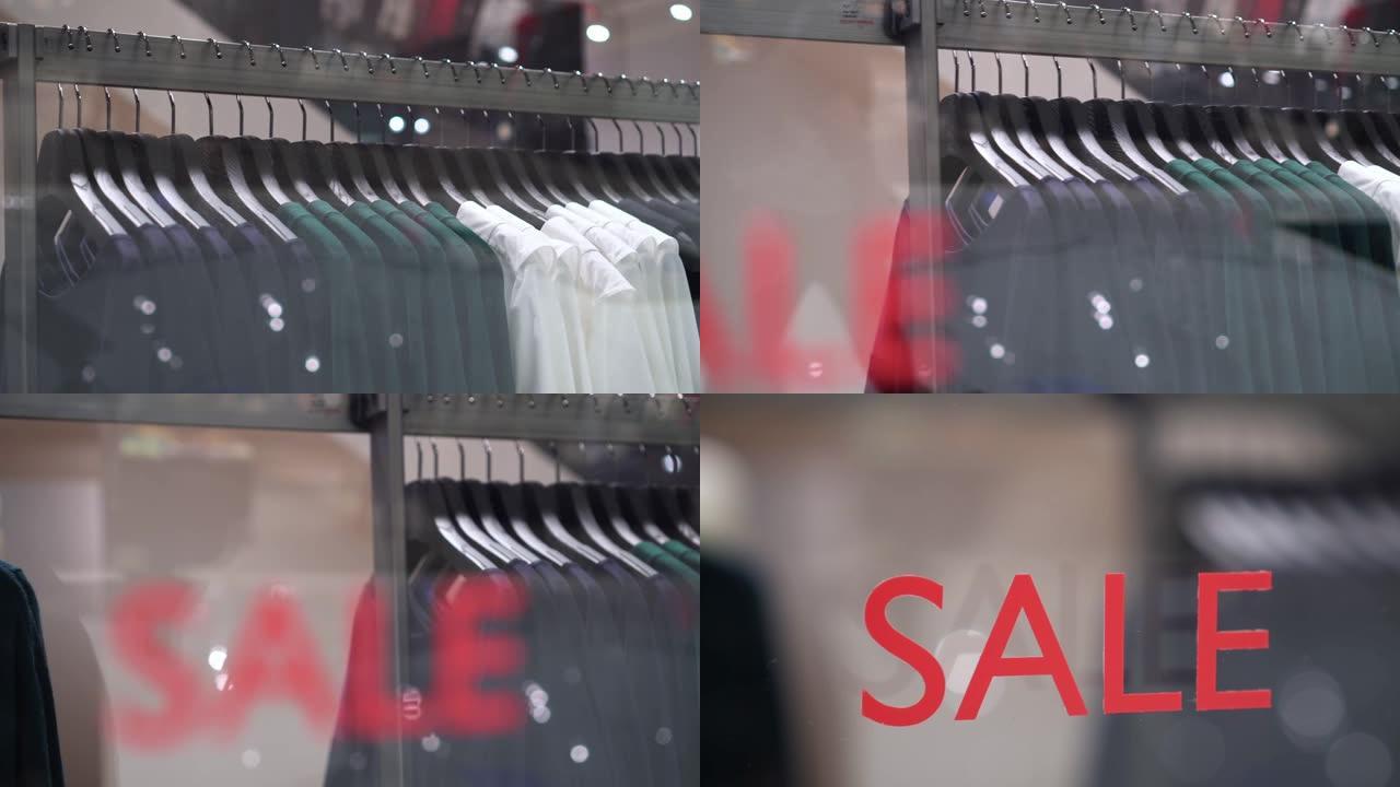 4k镜头在百货商店，购物中心和服装概念的时尚服装店的衣架上悬挂衣架和栏杆的销售展示