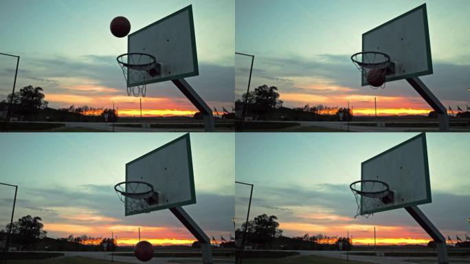 MS超级慢动作篮球在黄昏时落入室外篮球场的篮筐