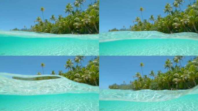 半水下: 清澈的水溅到镜头上，拍摄异国情调的岛屿。