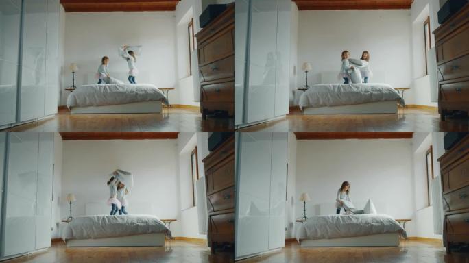 pigiama和pink tutu的两个小女孩姐妹在床上与枕头打架的真实照片
