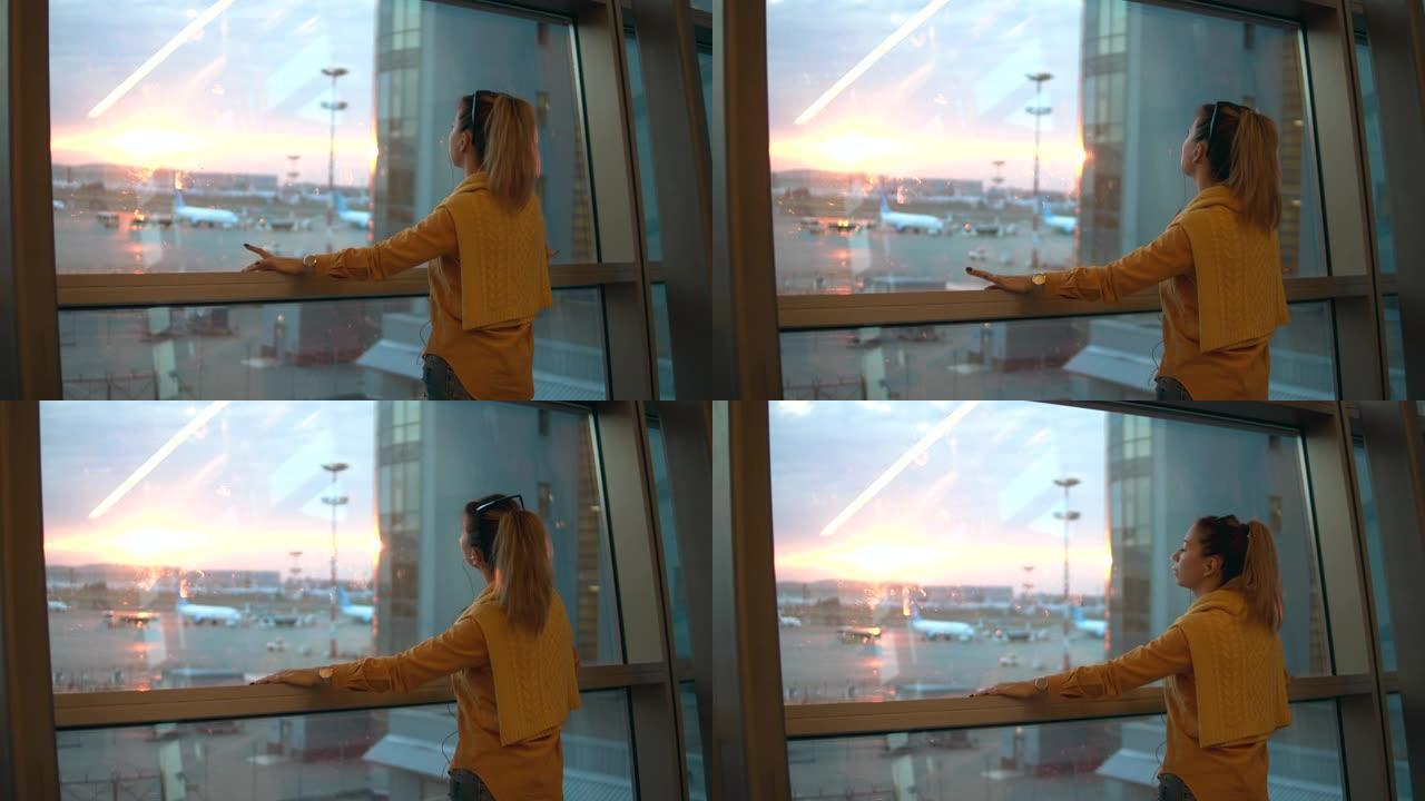 机场窗户和一个放松的女人透过它看