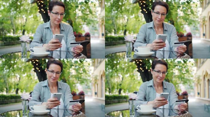 在街头咖啡馆使用智能手机用信用卡付款的女士慢动作