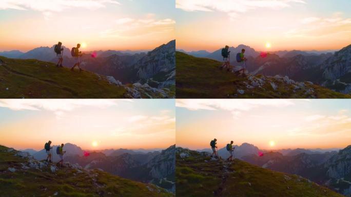 镜头耀斑: 活跃的女人和男友在日出时下山。
