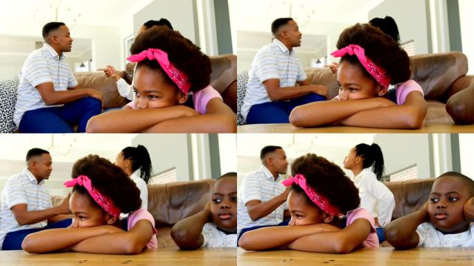 年轻的黑人父母坐在沙发上，在舒适的家庭里争吵的侧视图4k