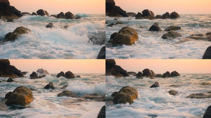 海浪溅到海滩上的岩石上。