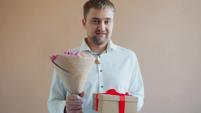 帅哥拿着礼盒一束鲜花独自微笑的画像