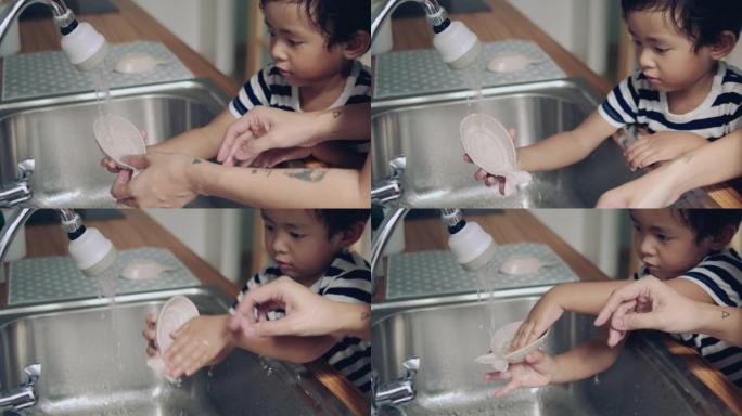 亚洲男婴帮助母亲完成家庭工作