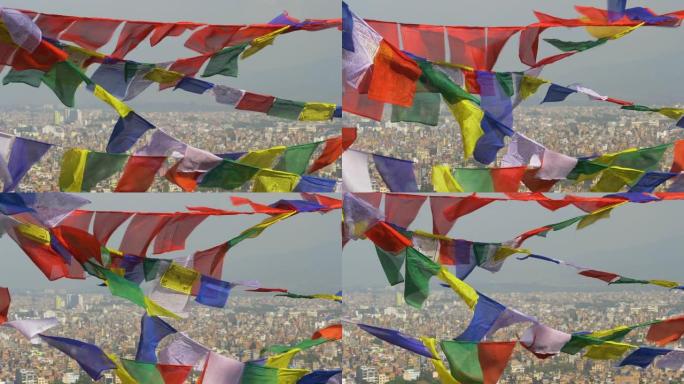 特写: 在飘动的祈祷旗后面，加德满都市的壮丽景色。