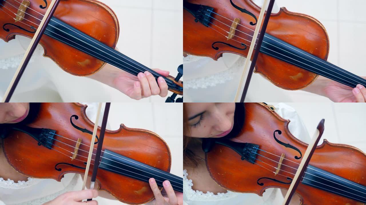 小提琴手将乐器放在肩膀上，在演奏时使用小提琴。