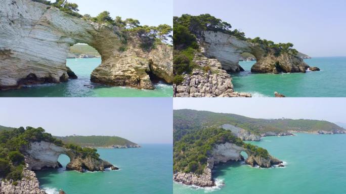 WS鸟瞰图拱形岩层和意大利加尔加诺国家公园阳光明媚的田园诗般的海洋上的海鸥
