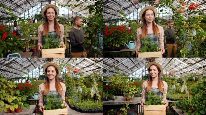 微笑的花店女人在温室里拿着一盒鲜花的慢动作