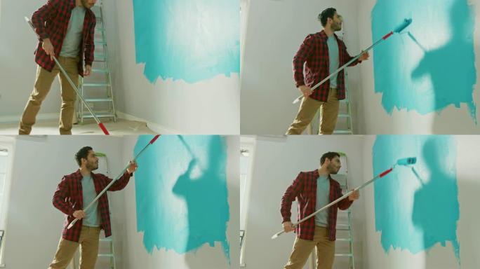 穿着棕色牛仔裤和红色格子衬衫的男人在长柄滚筒上涂上浅蓝色油漆，开始粉刷墙壁。油漆颜色为浅蓝色。他一边