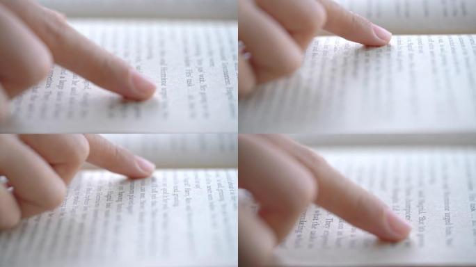 女人用手指指着文字看书