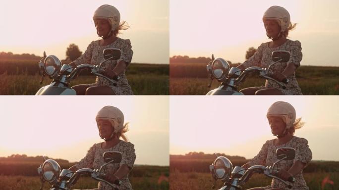 超级SLO MO女人在日落时在乡下骑踏板车