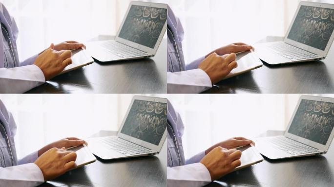 在医院使用数字平板电脑和笔记本电脑的听诊器穿着医生制服的女医生