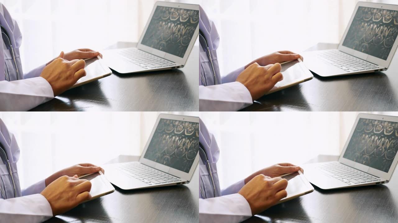 在医院使用数字平板电脑和笔记本电脑的听诊器穿着医生制服的女医生