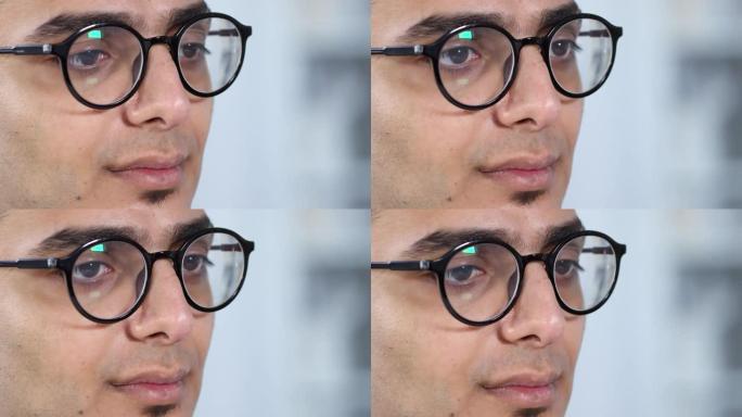 戴着眼镜的阿拉伯年轻人看着东西