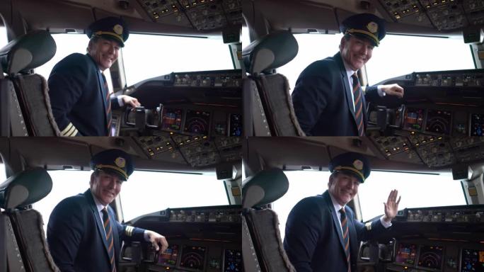 一架商用飞机的英俊飞行员坐在驾驶舱前看着相机微笑着挥手