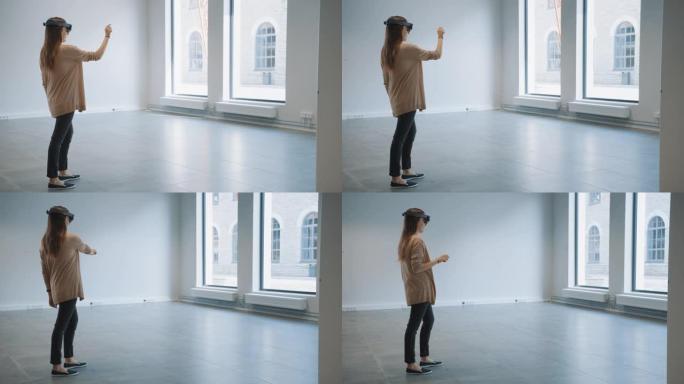 戴着全息增强现实眼镜的年轻时髦女人站在空荡荡的办公室里并绘制地图。她在空间里移动虚拟碎片。房间有视频