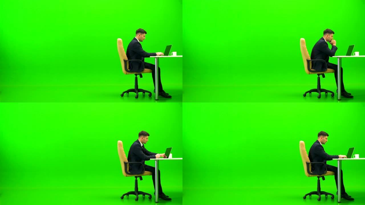 商人用笔记本电脑工作，在绿色背景上做运动