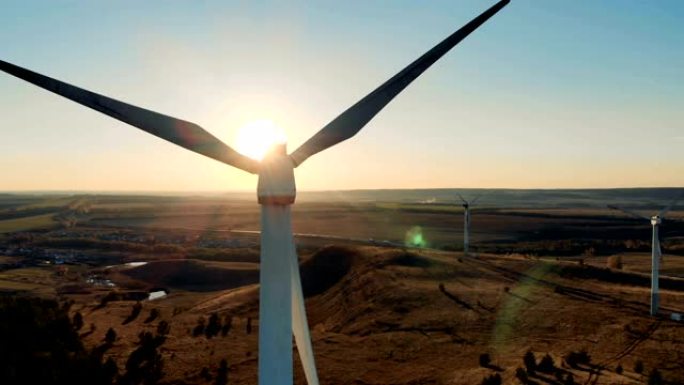风能、风能发电概念。日落和风力涡轮机产生能量