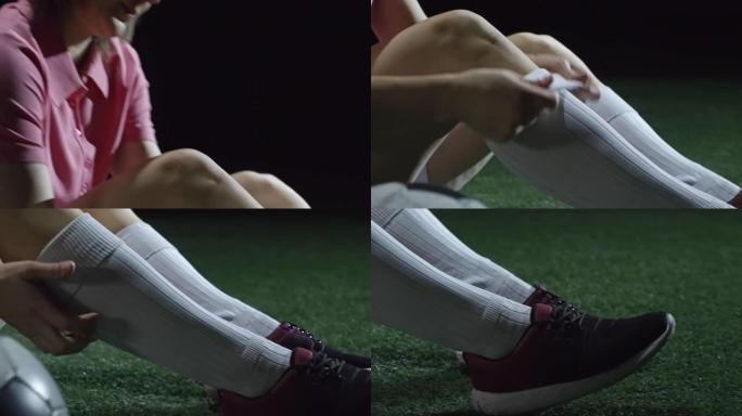 女足球运动员穿上袜子