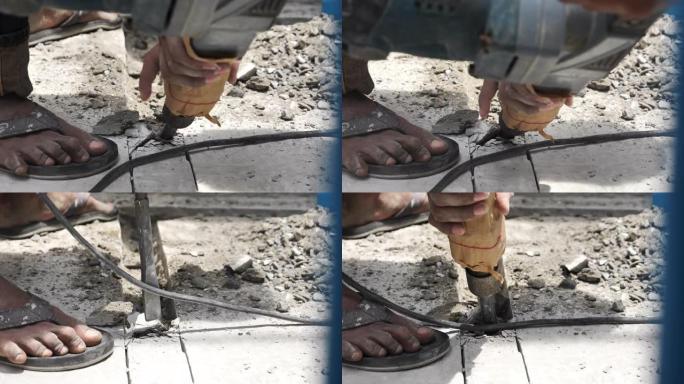 建筑工人在地板上使用手提钻凿子钻孔