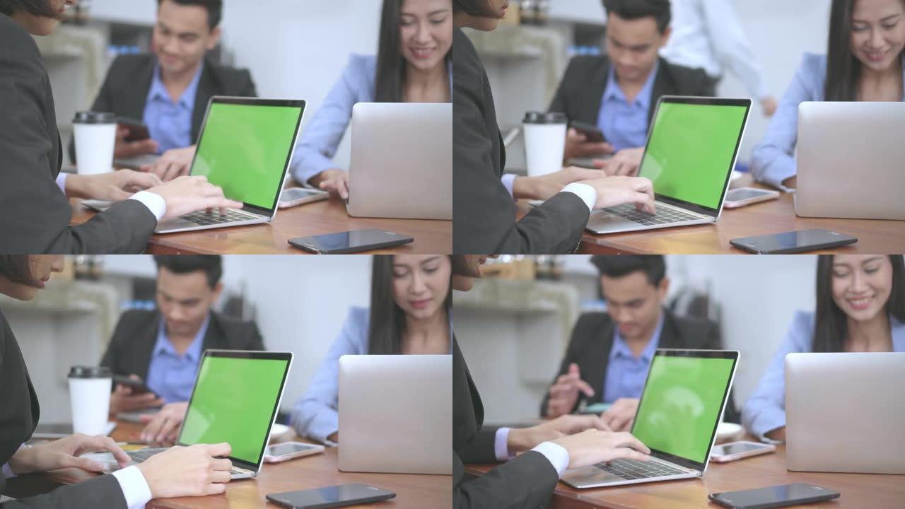 美丽的女人在会议时间坐在咖啡馆里的笔记本电脑上工作，绿屏