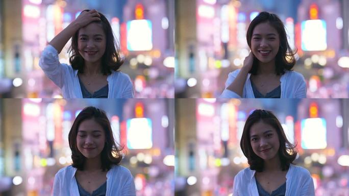 美丽的亚洲女孩的肖像晚上在镜头前微笑