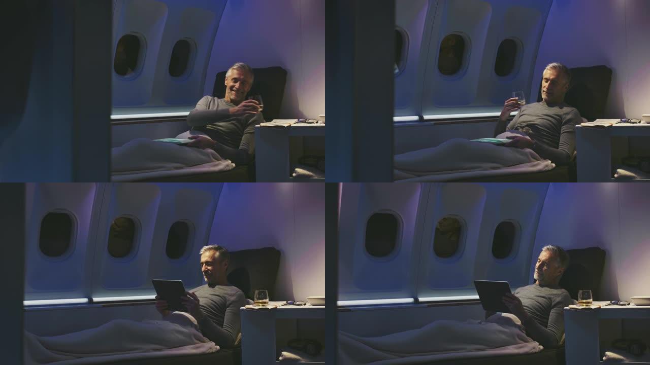 飞机上使用平板电脑的商人