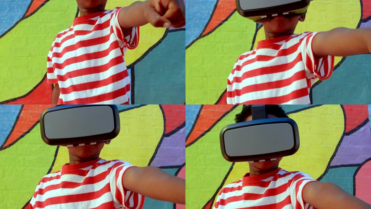 非裔美国男生在学校4k上使用虚拟现实耳机靠墙的前视图