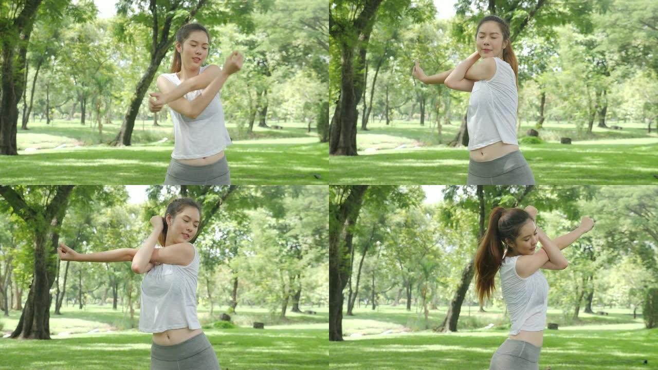 运动年轻的亚洲女性在公园的日出锻炼前热身和伸展。运动健康生活方式理念。
