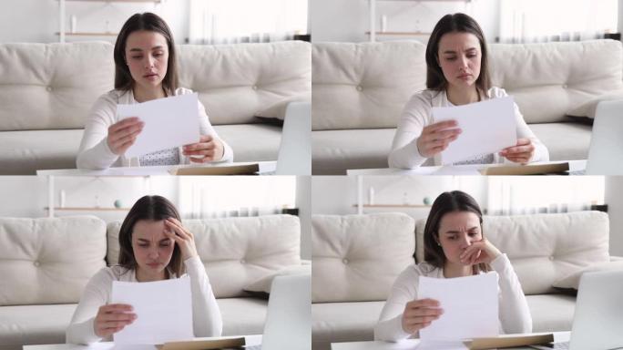 心烦意乱的年轻女子在纸质信中阅读坏消息