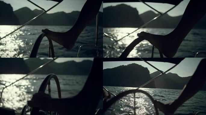 女人用腿操纵游艇。特写