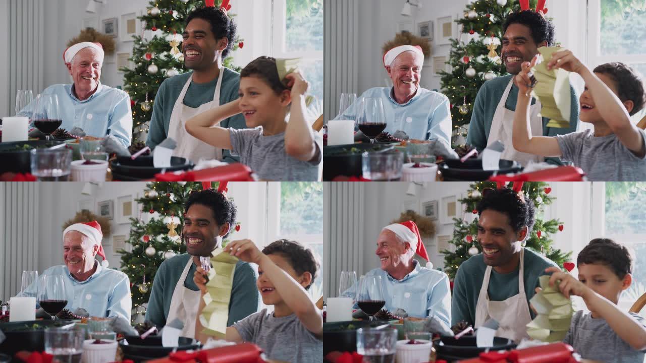 父亲与儿子和祖父在餐桌上一起享受圣诞大餐