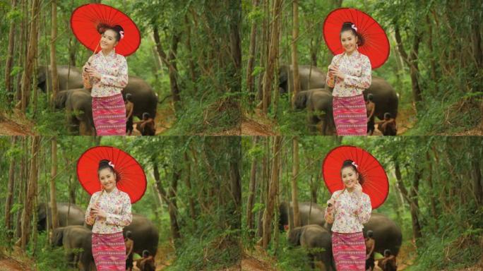 穿着传统东南亚服装的迷人亚洲女性肖像，在自然背景下看着镜头微笑。