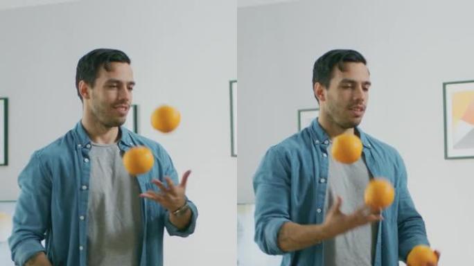 英俊的年轻人在客厅里玩弄橘子，为他的大性能训练。垂直屏幕方向9:16的视频素材