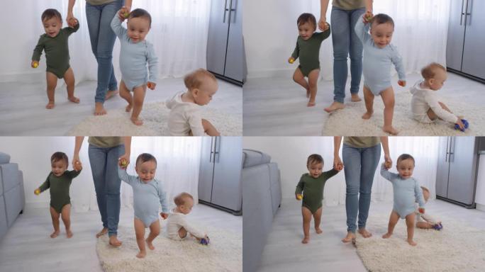 亚洲蹒跚学步的双胞胎在家学习和妈妈走路