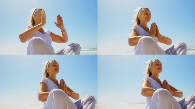活跃的白人女性在海滩上表演瑜伽的低角度视角4k
