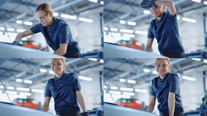 美丽的赋能女汽车修理工正在为服务中的车辆工作。她用棘轮时看起来很开心。专家戴着眼镜。她除去额头上的汗