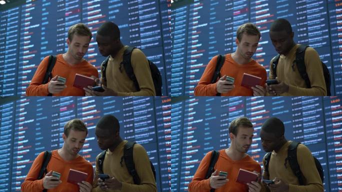 机场上的各种朋友在聊天时看着智能手机上的护照和登机牌