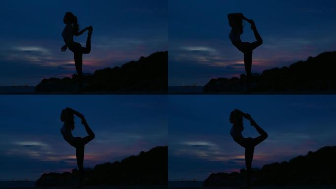 剪影年轻女子正在山海练习瑜伽。