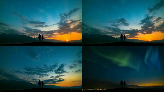 这对夫妇站在山顶上，面对北极光的日落
